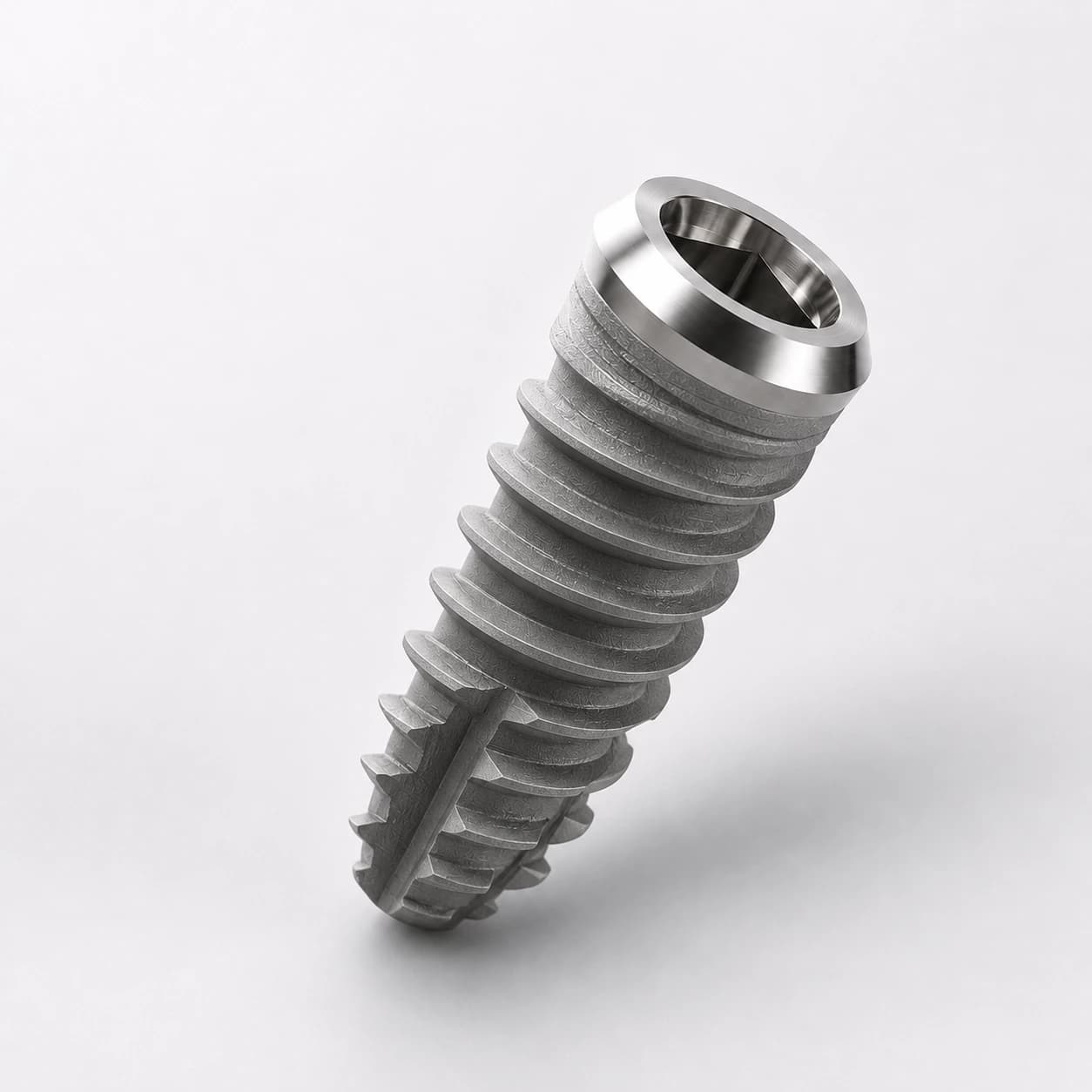Premium titanium dental implant photographed as a clean studio macro