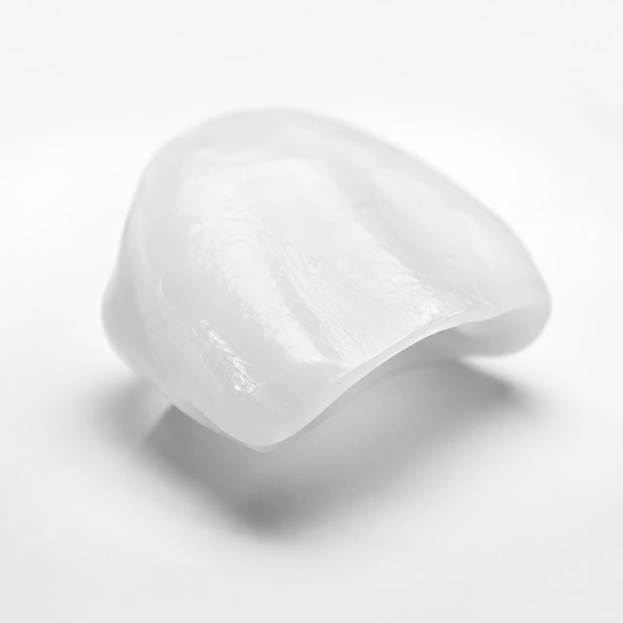 Premium porcelain veneer photographed on a minimal studio background